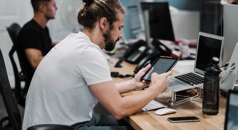 Young Men Working on Computers and Tablets for Managed IT Services in Carlsbad, CA